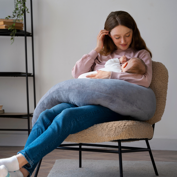 Toddler playing with educational toys while mother engages in early learning activities at home.